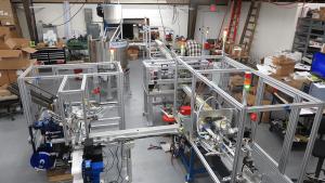 Fully automatic constant motion tubing system with box erector, labeler, packer, and closer