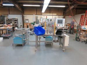 Medical grade operator loaded two-piece assembly machine with inspection and pass/fail bins