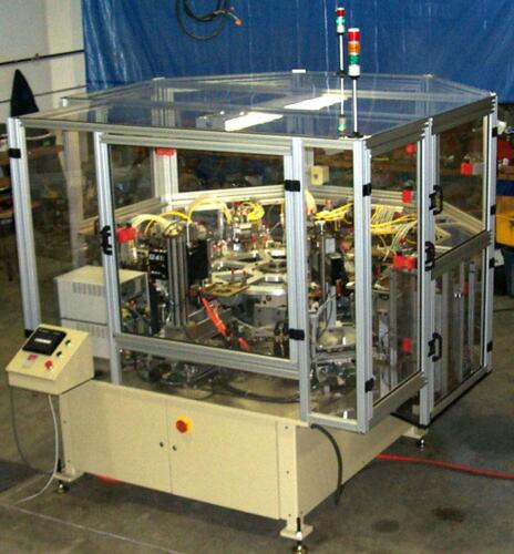 Automatic machine to assemble and spot weld a 4 layer automotive gasket